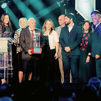 Rabbi Zalman Grossbaum, left and Toba Grossbaum, far right, Friendship Circle board members David and Dara Orbach, honorees Marlene and Larry Ritter, center, and the Ritter family