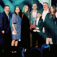 Rabbi Zalman Grossbaum, left, and Toba Grossbaum, far right, with Judy Elbaum, second from left, and her family, honoring the memory of Steven Elbaum.