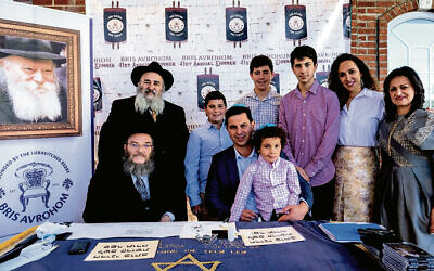 Rabbi Mordechai and Shterney Kanelsky, far left rear, and right; with the Jerusalem sofer, front left; and the Kanchik family of Livingston, as they begin to write the sefer Torah. (Courtesy Bris Avrohom)