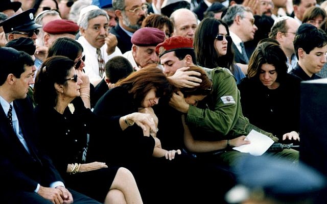 Noa and Jonathan Ben Artzi, the grandchildren of late Israeli Prime Minister Yitzhak Rabin, comfort their mother at the funeral. (Photo credit: Moshe Shai/Flash90