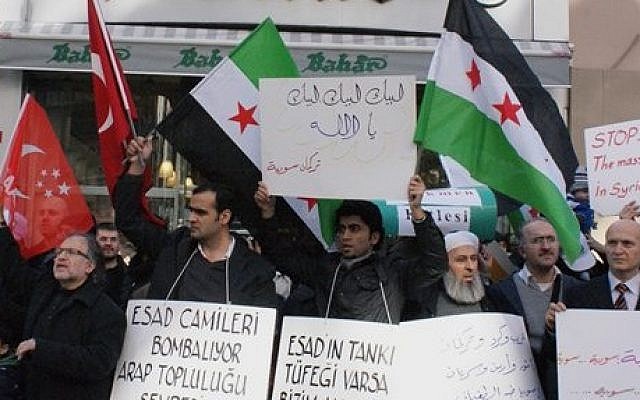 Syrians living in Turkey protest the latest killings by the Syrian regime. (photo credit: AP)