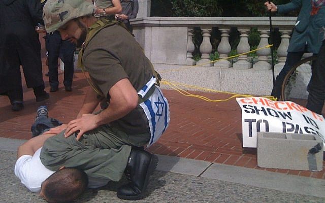 A man dressed as an Israeli soldier guarding a 'checkpoint' during an Apartheid Week event at UC Berkeley. (photo credit: CC-BY James Buck, Flickr)