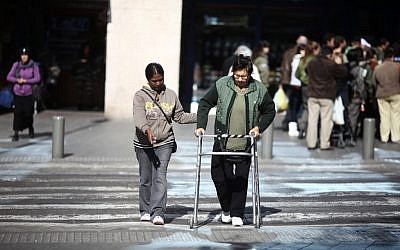 Helping an elderly Israeli cross the street in Tel Aviv in 2011 (photo credit: Kobi Gideon/Flash90)