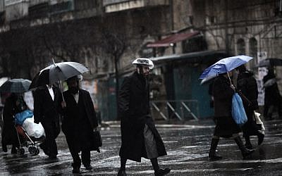 Ultra-Orthodox Jews in Jerusalem's Mea Shearim neighborhood weather the storm.(photo credit: Kobi Gideon/Flash90)