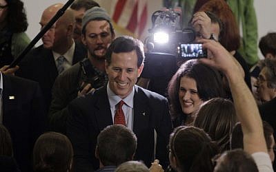 Republican presidential candidate, former Pennsylvania Sen. Rick Santorum, left, with his daughter, Elizabeth, right, visits with supporters during a campaign rally Sunday in Davison, Michigan. (AP Photo/Eric Gay)