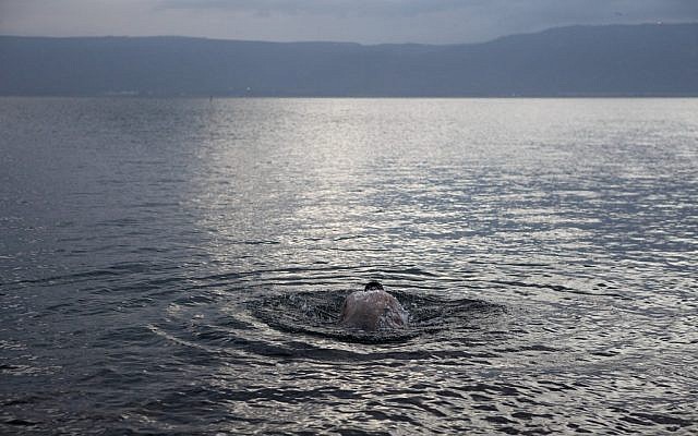 A man takes a swim in the Sea of Galilee (photo credit: Yaakov Nahumi/Flash90)