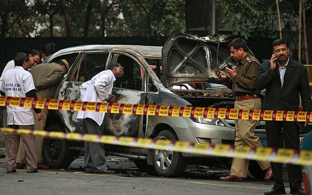 Indian police forensics experts investigating the scene after an explosion tore through a car belonging to the Israel Embassy in New Delhi, India (photo credit: AP/Kevin Frayer/File)