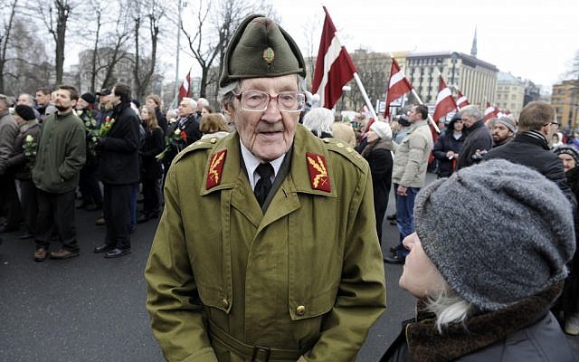 An elderly Latvian takes part in a ceremony to honor soldiers who fought in a Waffen SS unit during World War II, in Riga, Latvia, on Friday. (photo credit: AP/Roman Koksarov)