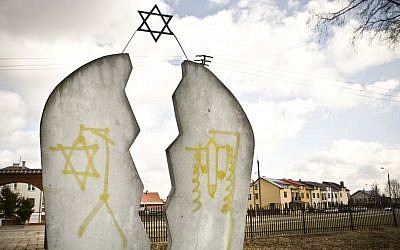 A monument found desecrated with anti-Semitic graffiti at a Jewish cemetery in Wysokie Mazowieckie, Poland (photo credit: AP/Jedrzej Wojnar)