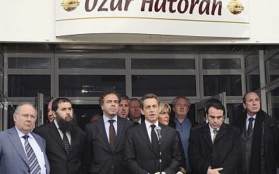 French President Nicolas Sarkozy, center, speaks in front of the Ozar Hatorah Jewish school in Toulouse, following a deadly shooting there on Monday morning. (photo credit: Eric Cabanis/AP)