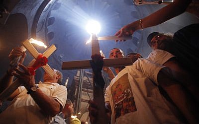 Orthodox Christian worshippers take part in the Holy Fire ceremony at the Church of the Holy Sepulcher in Jerusalem's Old City. (photo credit: Uri Lenz/Flash90)
