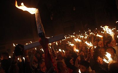Orthodox Christian worshippers take part in the Holy Fire ceremony at the Church of the Holy Sepulcher in Jerusalem's Old City. (photo credit: Uri Lenz/Flash90)