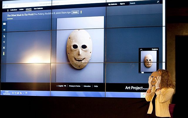 Curator Debby Hershman holds a 9,000 year old Neolithic stone mask during the launch of Google Art project at the Israel Museum in Jerusalem, on Tuesday (photo credit: AP/Oded Balilty)