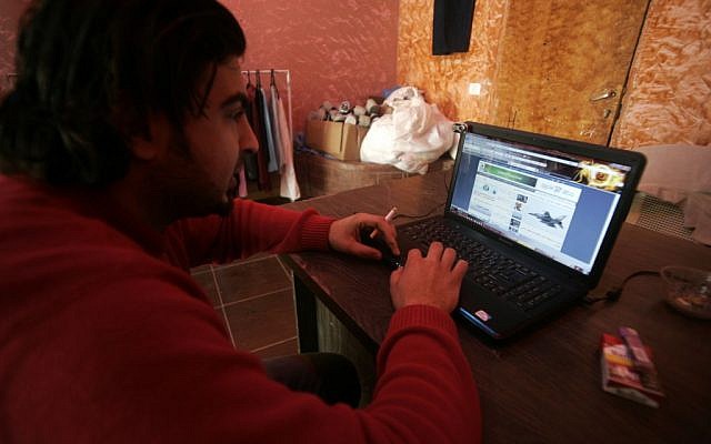 A Palestinian man using the Internet. (photo credit: Abed Rahim Khatib / Flash90)