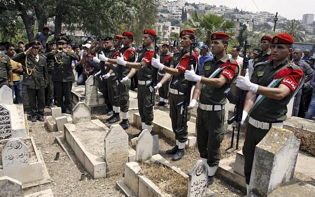 Palestinian members of an honor guard hold their rifles during the funeral of Jenin Governor Kadura Musa, in the West Bank city of Jenin, Wednesday. (photo credit: AP/Mohammed Ballas)