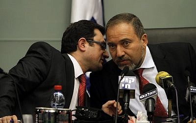 MK Robert Ilatov (left) speaks with Yisrael Beytenu head Avigdor Liberman during a party meeting at the Knesset (Miriam Alster/Flash90)