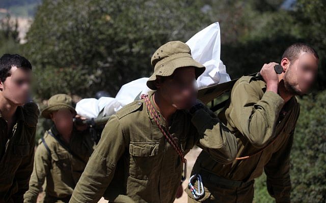 .Soldiers carrying the body of a soldier who committed suicide at a stalactite cave near Beit Shemesh in March 2011 (Photo credit: Abir Sultan/ Flash 90)