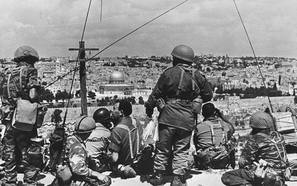 Mordechai Gur (seated, with black curly hair) and his troops survey the Old City before launching their attack in the 1967 Six Day War (photo credit: Wikimedia Commons CC BY-SA/Mazel123)