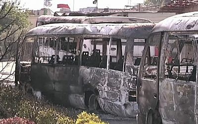 This image made from video released by the UN observer mission in Syria and accessed in June 2012 purports to show destroyed buses after fighting in Damascus, Syria. (photo credit: UNSMIS via AP video)