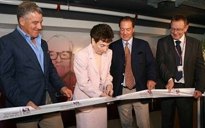 Aviva Ofer, wife of the late Sammy Ofer, flanked by their sons, Eyal (r) and Idan (l), cuts the ribbon at this week's Rambam event. Prof. Rafi Beyar, RHCC Director and CEO, looks on (far r).  (photo credit: Paul Melling-RHCC)