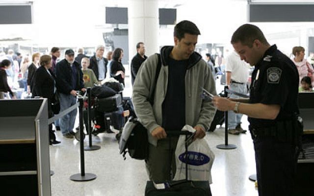 Illustrative photo of a customs officer checking a passenger's passport at Washington-Dulles International Airport. (James Tourtellotte/Department of Homeland Security)