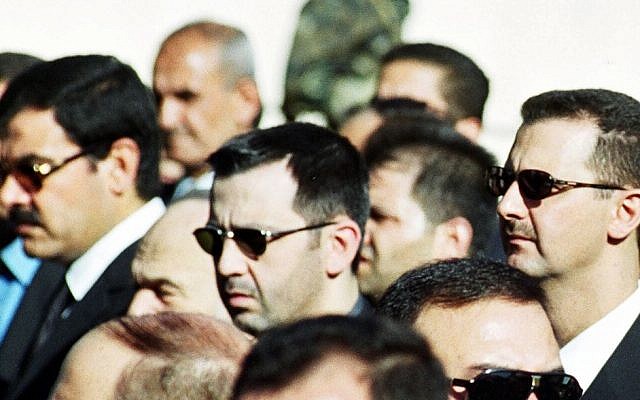Syrian President Bashar Assad, right, his brother Maher, center, and brother-in-law Major General Assef Shawkat, left, stand during the funeral of late president Hafez Assad in Damascus, Syria on June 13, 2000 (photo credit: AP)