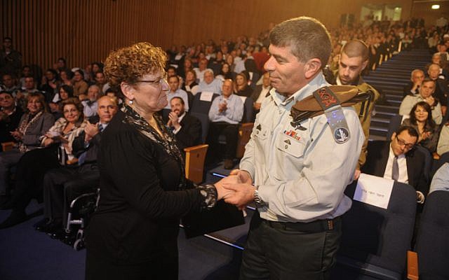 Miriam Peretz, mother of two fallen Israeli soldiers, shakes hands with outgoing Chief of Staff Lieutenant General Gabi Ashkenazi during a farewell event in Tel Aviv, in 2011. In 2012 a burglar stole mementos of her sons from the Peretz home in Jerusalem. (photo by Michael Shvadron/IDF Spokesperson/Flash90)