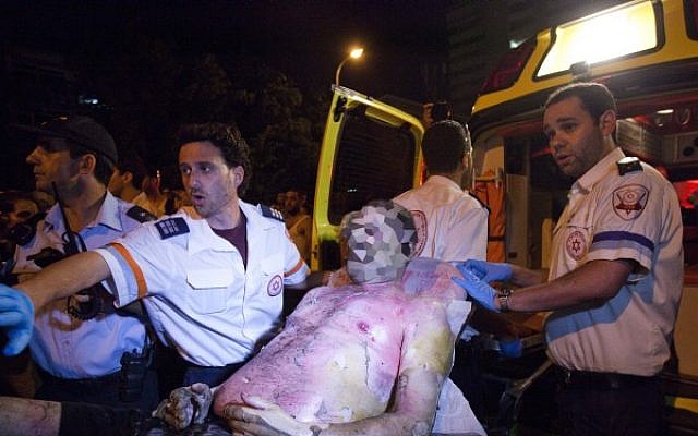 Ambulance crews tend to Moshe Silman, who set himself on fire during a protest march in Tel Aviv on Saturday night. (Photo credit: Tali Mayer/Flash90)