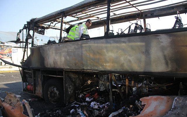 ZAKA emergency rescue worker searches for human remains on a bus that was blown up in a terror attack against Israeli tourists in Burgas, Bulgaria, July 19, 2012. (Dano Monkotovic/Flash90)
