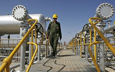 An oil technician in an oil field southwest of Tehran. (photo credit: AP/Vahid Salemi)