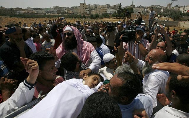 People carry the body of 6-year-old Syrian boy Bilal El-Lababidi during his funeral in Ramtha, Jordan, Friday, July 27, 2012. The boy was shot dead by Syrian border guards, his mother said. (Photo credit: AP/Mohammad Hannon)