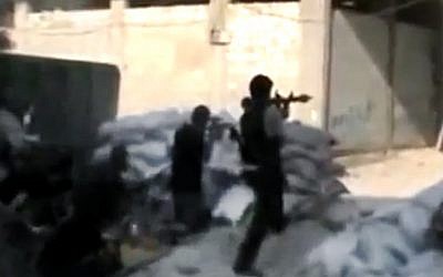 Free Syrian Army soldiers clash with Syrian government forces in Damascus last Sunday (photo credit: AP/Ugarit News)