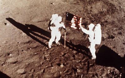 This July 20, 1969 file photo provided by NASA shows Apollo 11 astronauts Neil Armstrong and Edwin E. "Buzz" Aldrin, the first men to land on the moon, plant the U.S. flag on the lunar surface. (photo credit: AP Photo/NASA)
