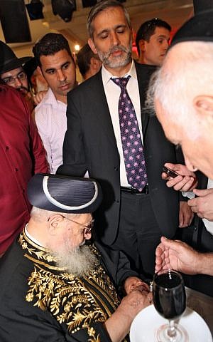 Eli Yishai, standing, attends a circumcision ceremony in Jerusalem (photo credit: Matanya Tausig/Flash90)