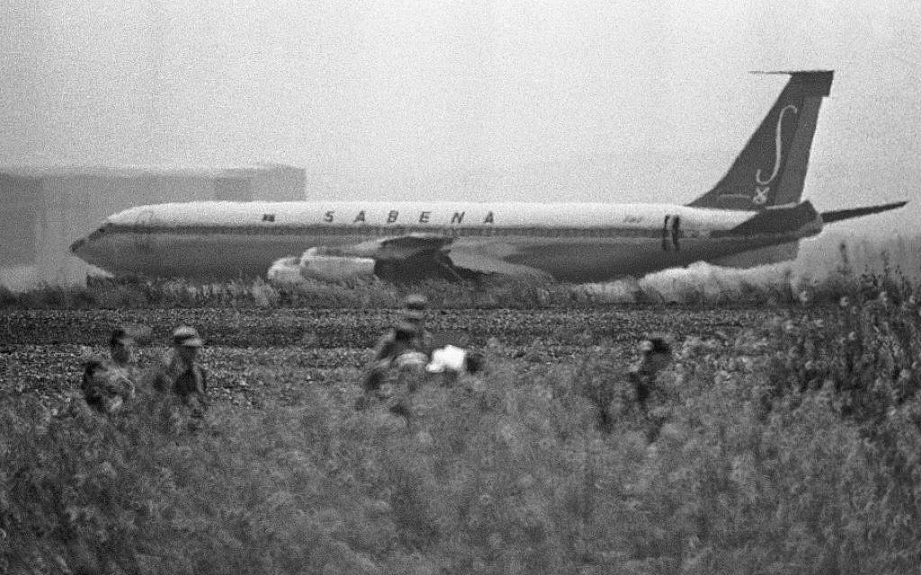 In this May 15, 1972 file photo, Israeli troops patrol fields around runway 26 where the hijacked Sabena plane sits grounded and unable to take off from Lod International Airport. (AP Photo)