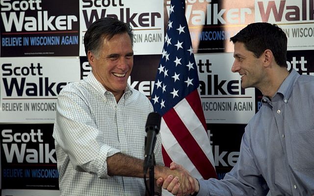 Republican presidential candidate, former Massachusetts Gov. Mitt Romney, left, shakes hands with US Rep. Paul Ryan, R-Wis., Chairman of the House Budget Committee, in March. (photo credit: AP/Steven Senne, File)
