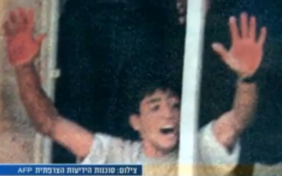 Aziz Salha waving his bloody hands after the lynch of 2 IDF reservists in Ramallah in 2000 (photo credit: screen capture, YouTube)