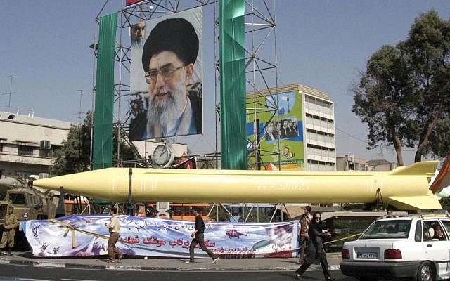 A military exhibition displays the Shahab-3 missile under a picture of the Iranian Supreme Leader Ayatollah Ali Khamenei, in Tehran, in 2008. (photo credit: AP/Hasan Sarbakhshian)