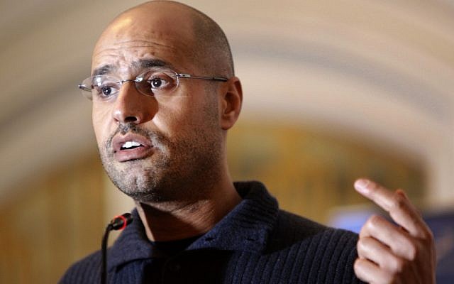 Saif al-Islam Gaddafi speaks to the media at a press conference in a hotel in Tripoli, Libya, in February 2011. The International Criminal Court prosecutor had asked judges to issue arrest warrants for Libyan leader Muammar Gaddafi and son Saif, for crimes against humanity, accusing them of deliberately targeting civilians in their crackdown against rebels. (photo credit: AP Photo/Ben Curtis, file)