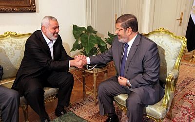 Hamas PM Ismail Haniyeh (left) during a meeting with Egyptian president Mohammed Morsi in Cairo, July 26 (photo credit: Mohammed al-Ostaz/Flash 90)