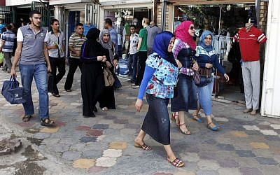 Iraqis shop at a marketplace in northern Baghdad's Kazimiyah neighborhood on Sunday, September 2 (photo credit: AP/Karim Kadim)