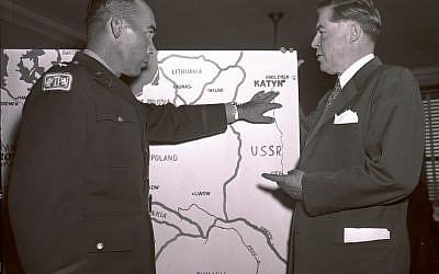 In this Oct. 11, 1951 file photo, Lt. Col. Donald B. Stewart, left, locates the site of a mass grave near near Smolensk, Russia, to Rep. Ray Madden, D-Ind., during a special House Committee hearing in Washington. Stewart and Lt. Col. John H. Van Vliet Jr., were among a group of British and American prisoners forced by the Germans to see the mass grave where murdered Polish officers were buried. (photo credit: AP Photo/File)