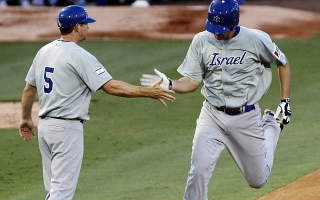 Israel's Nate Freiman, right, is congratulated by third base coach Mark Loretta after hitting a home run against South Africa in the first inning of a World Baseball Classic qualifier baseball game in Jupiter, Florida, on Wednesday. (photo credit: AP Photo/Alan Diaz)