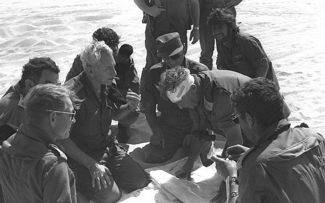 Former chief of staff Haim Bar-Lev, center left, consults with Maj. Gen. Ariel Sharon (with bandage) and Moshe Dayan, center, during the Yom Kippur War. (photo credit: GPO/Flash90)