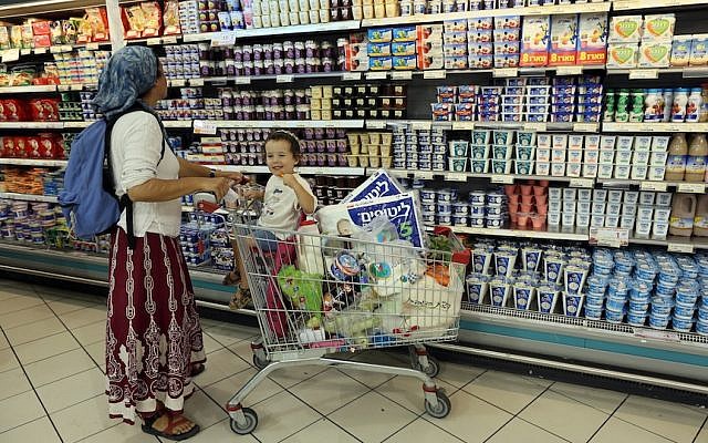 Illustrative: A woman shops with her son at the Rami Levy supermarket in the Gush Etzion settlement bloc. (Nati Shohat/Flash90)