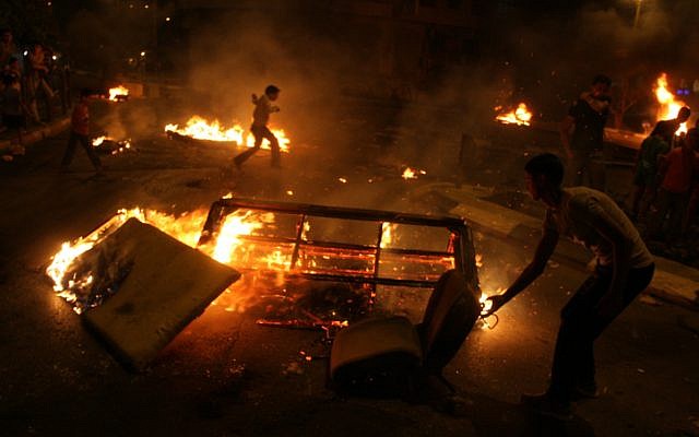 Palestinian youth burn tires and block a main road in the West bank city of Ramallah as they protest against high costs of living on Saturday, Sept. 08 (photo credit: Issam Rimawi/Flash90)