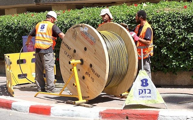 Bezeq workers installing fiber optic cables (Photo credit: Courtesy)