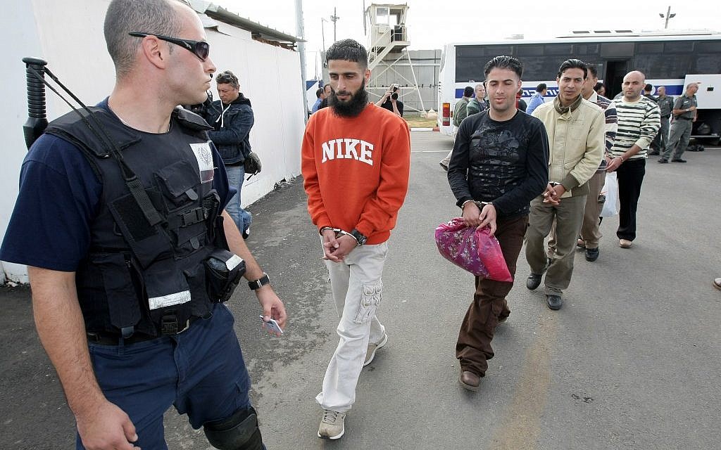 An Israeli prison guard escorts Palestinian prisoners before their release from the Ofer Prison near the West Bank town of Ramallah, December 15, 2008 (photo credit: Kobi Gideon/Flash90)