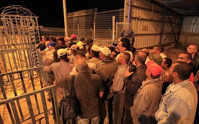 Palestinians line up before dawn to cross a checkpoint near Beersheba to attend work in Israel (photo credit: Tsafrir Abayov/Flash90/File)