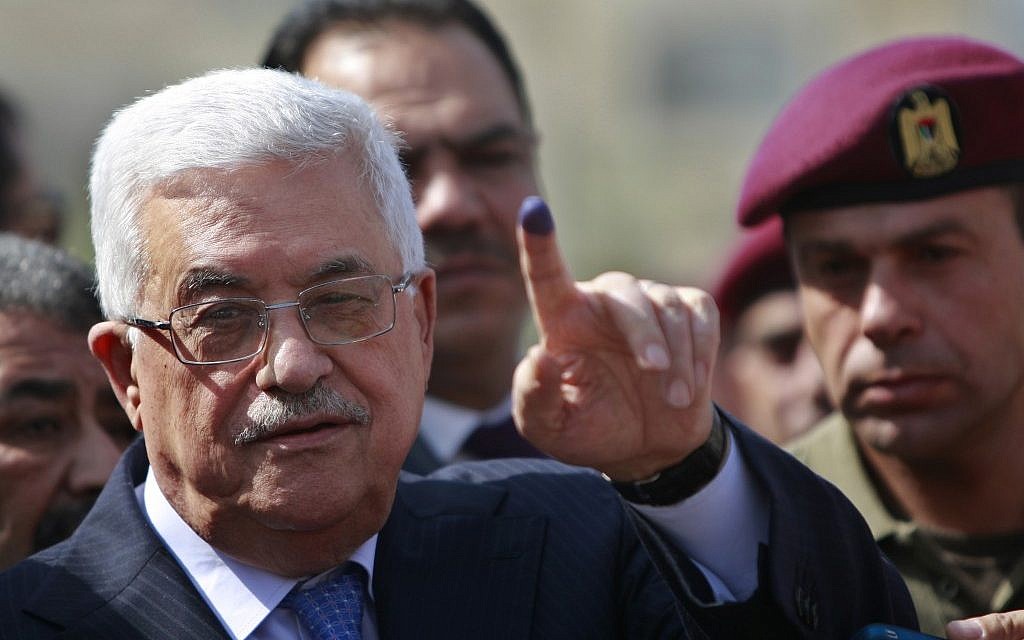 Palestinian Authority President Mahmoud Abbas shows his ink-stained finger after casting his vote during local elections at a polling station in the West Bank city of Ramallah, October 20, 2012. (AP/Majdi Mohammed)